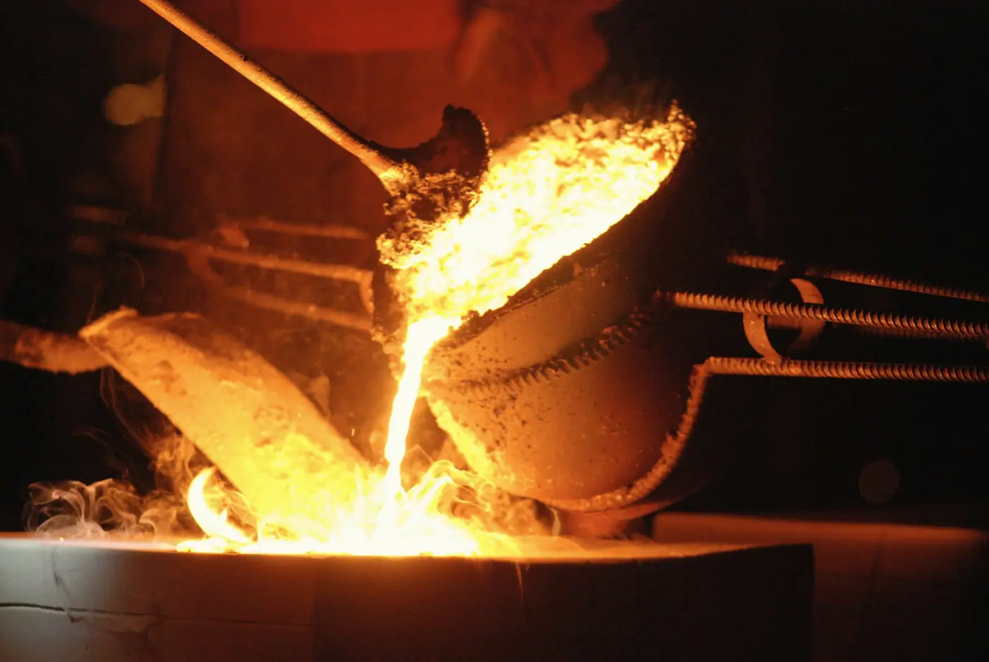 Metal melting in a crucible over a fire